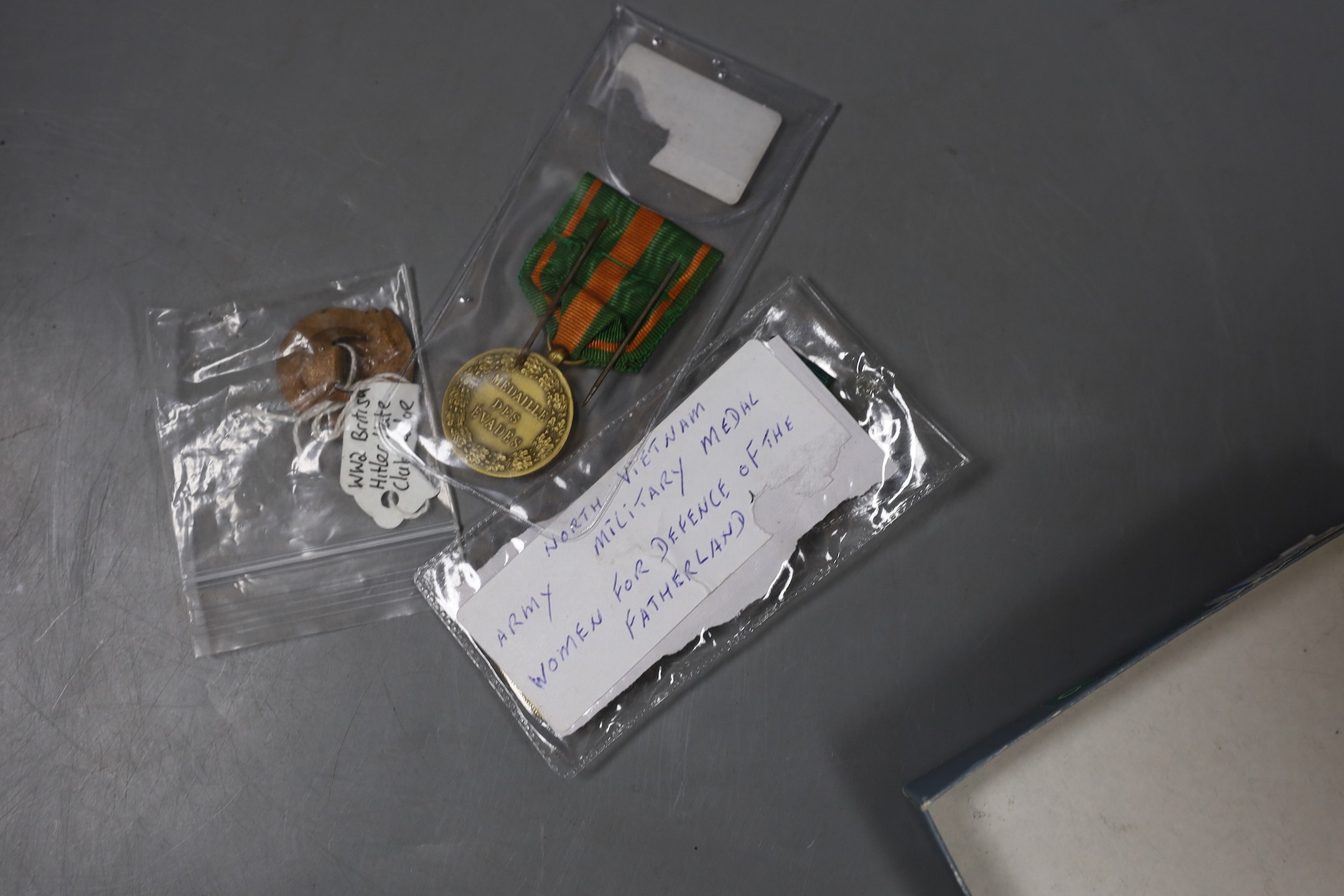 WWII interest: a Churchill composition drinks dispenser, France Escapees medal, a British Hitler hate club badge and a North Vietnam women's Defence of the Fatherland medal